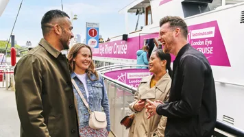 Group of friends laughing at the London Eye River Cruise Pier